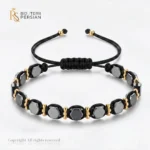 Cumperi o bratara aur galben cu snur si hematit hexagonal din aur 14K cu mărgele din hematit, biluțe din aur și nod reglabil. Comandă online!
