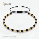 Bratara aur galben cu snur si spinel alternat din aur 14K cu bila centrala si margele de aur si spinel negru alternate simetric