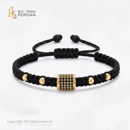 Bratara aur galben cu snur si zirconiu negru din aur 14K cu cilindru central incrustat si bila din aur pe impletitura neagra